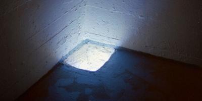 ill. 2a: EMERGING, 1999 - EMERGING, 1999. Video installation in the floor, ca. 30 x 40 cm.